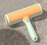 Pet Hair Remover Brush on soft carpet, designed to lift pet hair effortlessly from furniture and clothes.