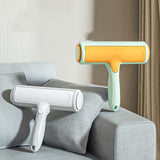 Pet Hair Remover Brush in two colors on a sofa, designed for removing pet hair effortlessly from furniture.